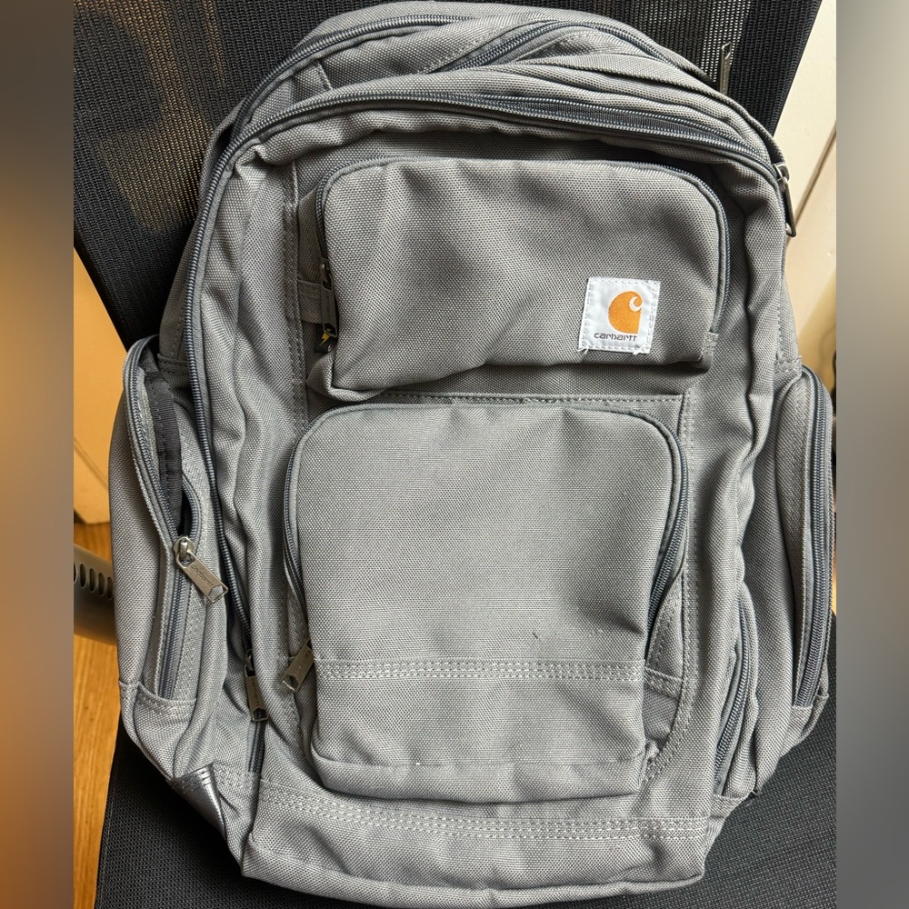 Grey Carhartt backpack. Barely used. Many many pockets, can be used as a daily.
